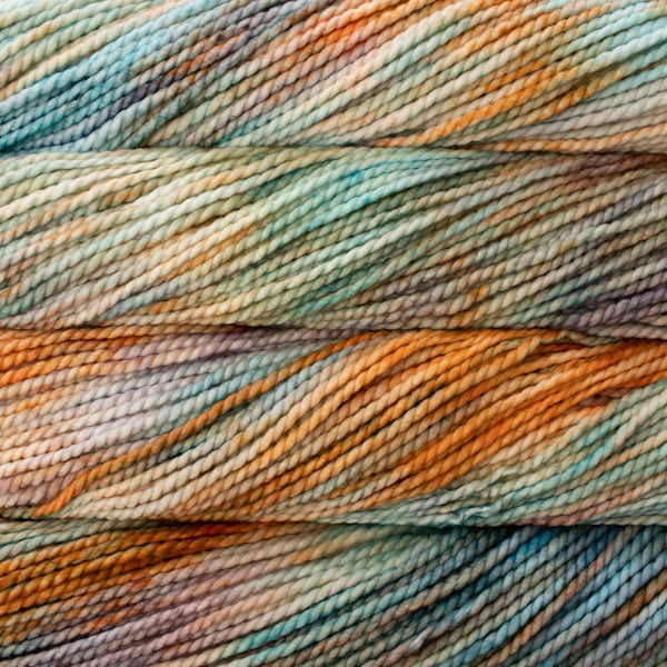 Close-up of multicolored yarn with shades of blue, green, and orange.